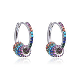 Boucles d'oreilles créoles, rhodiées ou rosées, serties de zirconiums multicolores, en Argent - 925/000.  Les créoles, véritables accessoires de mode intemporels, ajoutent une touche d'élégance à n'importe quelle tenue.  CARACTERISTIQUES :  Poids (gr) : 3.20 Matière : Argent - 925/000  19862 - 20488